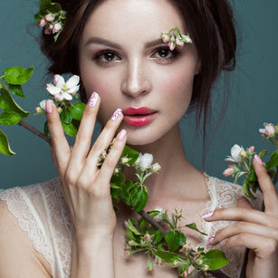 Model with floral beauty styling and elegant nail art
