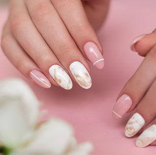 Glossy pink manicure with white marble accent nails